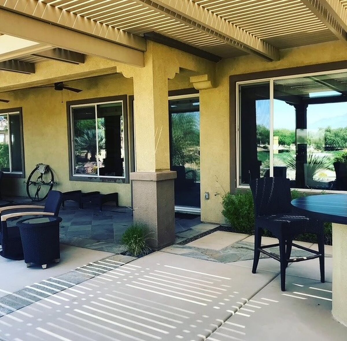 Covered patio with stucco columns and a wood pergola